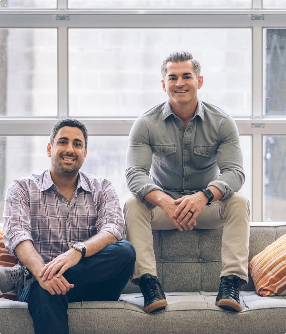 Founders Pete and Rashid sitting on a couch